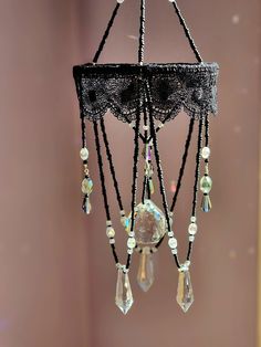 a black chandelier with beads hanging from it