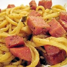 pasta with ham and onions on a white plate, ready to be eaten for lunch