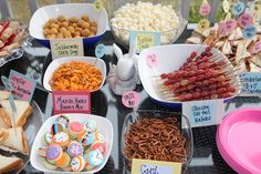 a table topped with lots of different types of food and desserts next to each other