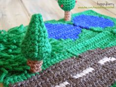 there is a crocheted blanket with trees on it