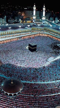 an aerial view of the ka'bah at night, with many people around it