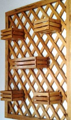 a wooden wall sculpture made out of wood planks and latticed with white background