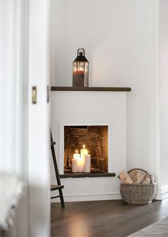 a fireplace with two lit candles in it