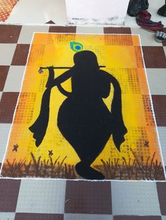 a painting is shown on the floor in front of a checkerboard pattern with a silhouette of a person holding a trumpet