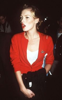 a woman in a red jacket and white shirt