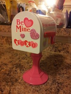 a pink and white mailbox sitting on top of a counter