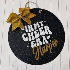 a black and gold door mat that says, in my cheer era harper