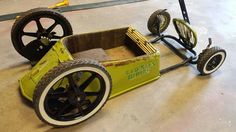 an old fashioned pedal car is being worked on