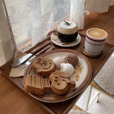 there is a plate with cookies and coffee on it