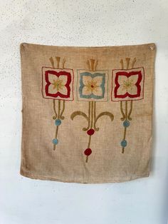 an old wall hanging with flowers on it