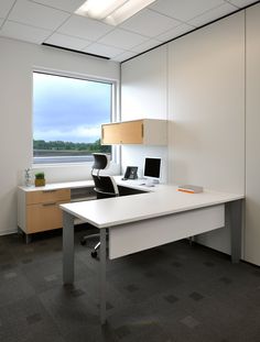 an empty office with a desk and chair