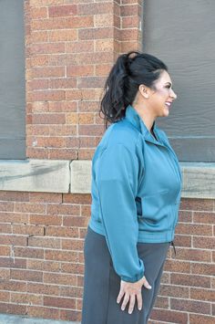 Stay warm and stylish with the Curvy Mock Neck Zip-Up Active Jacket. Designed with a full zip and mock neck, this jacket provides cozy warmth before and after your workouts. Its cuffed hemline and wrists ensure a snug fit, while the relaxed silhouette offers comfort and ease of movement. Practical hand pockets add convenience, perfect for stashing small essentials. Crafted from a blend of 51% modal, 44% polyester, and 5% spandex, the jacket boasts a soft feel and durable construction. The four-w Active Jacket, Active Lifestyle, Zip Up, Stay Warm, Snug Fit, Mock Neck, Stretch Fabric, Zip Ups, Spandex