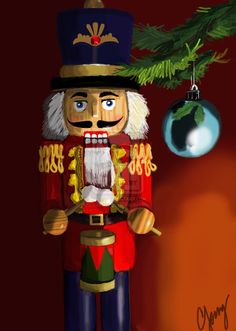 a nutcracker ornament hanging from a christmas tree with an ornament