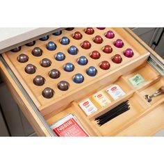 an open drawer with some chocolates and other items in it on top of a counter