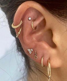 a woman with three different ear piercings