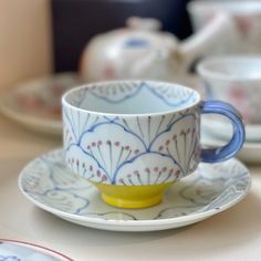 a cup and saucer sitting on top of a table