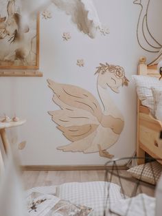 a child's bedroom decorated in white and neutrals with an angel - themed wallpaper