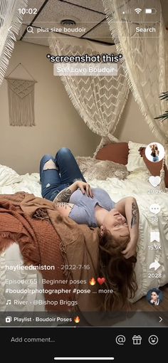 a woman laying on top of a bed next to a white net hanging from the ceiling