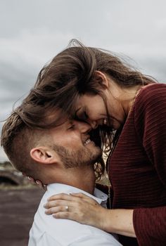 a man and woman embracing each other outside