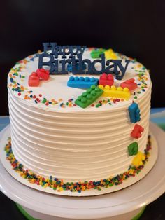 a birthday cake with white frosting and colorful decorations