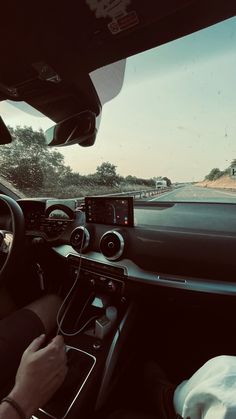 a man driving a car on a highway