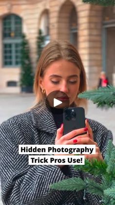 a woman holding a cell phone in her hand and looking at it with the caption hidden photography trick pros use