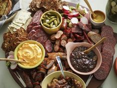 an assortment of meats and condiments on a platter