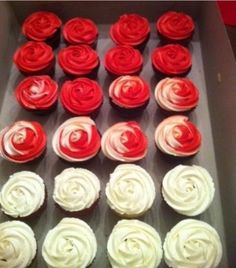 cupcakes with red and white frosting in a box on a table top