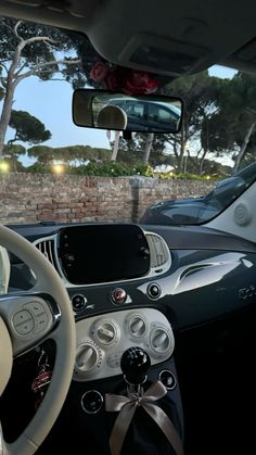 the interior of a car with its steering wheel and dash lights on, as seen from inside