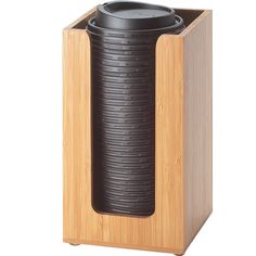 a black vase sitting on top of a wooden box