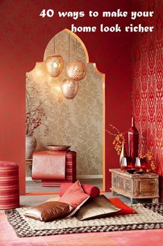 a living room with red walls and decorative items on the floor in front of it