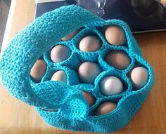 an egg carton filled with eggs sitting on top of a wooden table next to a book