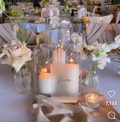 a table with candles and flowers on it