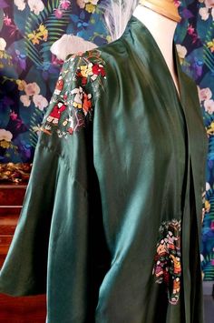 "An original, late 1930s, early 1940s Chinese silk kimono robe with exquisite hand embroidery. This piece is the most unusual colour..a soft forest green as the outer shell and lined in leaf green cotton. Condition wise, there is a the odd mark to the back of the right hand sleeve and a little age related wear to the lining, bit overall, it is structurally sound and in lovely vintage condition. Labelled as a small, this is photographed on my UK size 8 mannequin. Nape to hem 47\" Back of shoulder Green Embroidered Kimono With Kimono Sleeves, Vintage Kimono With Floral Embroidery, Embroidered Kimono, Chinese Silk, Silk Kimono Robe, Japanese Flowers, Leaf Green, Womens Robes, Silk Kimono