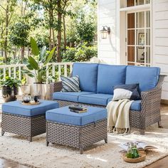 a blue couch and ottoman on a porch