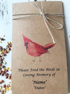 a brown paper bag with a red bird on it next to some nuts and seeds