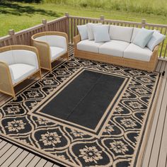 a black and beige rug on a deck with wicker chairs, couches and coffee table