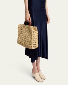 Rabanne "Sac a Main" raffia, leather, and brass tote bag with disclink accents     Rolled top handles     Detachable shoulder strap    Can be worn as a top handle or shoulder bag     Open top with magnetic closure     Approx. 10.3"H x 14.5"W x 6.2"D    Item Weight (Lbs.): 1.3    Imported Raffia Tote Bag, Leather And Brass, Evening Flats, Cocktail Jacket, Elements Of Style, Blazer With Jeans, Platform Pumps, Open Top, Lingerie Sleepwear