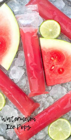 watermelon ice pops with limes and lemon wedges on the side, surrounded by crushed ice