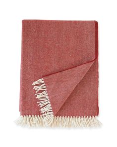 a red and white blanket with fringes on it, folded in two different colors