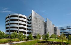 an office building in the middle of a grassy area