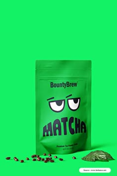 a bag of matcha on a green background next to some black and white candies