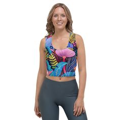 Look fabulous in an all-over printed, body-hugging crop top, now offering FREE SHIPPING to the US, Canada, EU, and UK! The artwork This artwork is a vivid and richly detailed depiction of a variety of African flowers, showcasing a tapestry of vibrant colors and intricate patterns. The piece features a dynamic assortment of floral elements, including large, bold blossoms and delicate foliage, all set against a deep blue background. The use of contrasting colors and stylized forms captures the lus Workspace Essentials, French Collection, African Flowers, Cropped Tops, Spring Collection, Blue Backgrounds, Laptop Sleeves, Contrasting Colors, Crop Tops Women