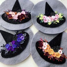 four hats with flowers on them sitting on a table