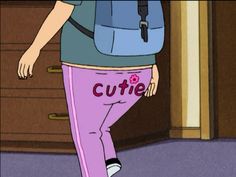 a woman in pink pants and a blue shirt with the word cutie on it