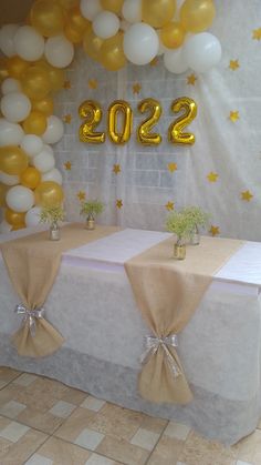 the table is set up with balloons and decorations