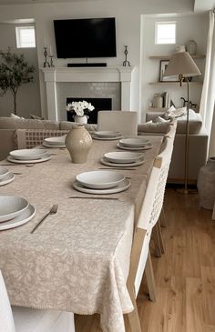 a dining room table is set with place settings