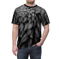 Elevate your wardrobe with our Mens "Raven Feathers" All-Over Print T-Shirt!  Crafted from luxurious 100% polyester, this tee is a testament to comfort and style. Inspired by the mystical allure of ravens encountered during our travels across America, each feather on this shirt tells a story of wanderlust and a deep connection to nature.  Key Features: * Premium 100% polyester for a soft and comfortable fit. * All-over print design inspired by the captivating beauty of ravens. * A tribute to our love of travel and nature. *  Wear the Journey: Experience the magic of the Raven Feathers T-Shirt as it transports you to the enchanting landscapes that fueled its inspiration. Perfect for those who seek comfort without compromising on style. Perfect Gift for Nature Lovers: Looking for a unique gi Black Crew Neck T-shirt With Digital Print, Black T-shirt With All Over Print, Relaxed Fit, Black Cotton T-shirt With Digital Print, Raven Feathers, Raven Feather, Tee Shirt Homme, Gifts For Nature Lovers, Ravens, Free Spirit