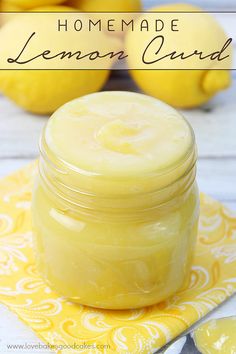 a jar of lemon curd sitting on top of a yellow napkin next to some lemons