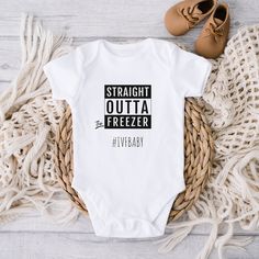 a white bodysuit with the words straight outa freezer on it next to some shoes